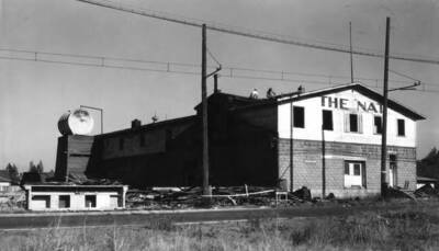 The "Nat" (Natatorium) located on the north side of Sixth Street between Almon and Asbury streets was the Safford Apple Packing Plant in the early 1900s. Nathaniel Williamson of the famed  Williamson Store operated a creamery in the building before remodeling it into a natatorium. This was a popular place during the 1920s. It was then remodeled and occupied for many years by the Inland Motor Freight. Then remodeled in 1977 by Kenworthy into a restaurant and lounge. The Natatorium Building at the right [90-2-146] originally was the Safford Apple Packing Plant until the production of apples in the area went out in the early 1900s. Nathaniel Williamson of the famed Williamson Store operated a creamery in the building before remodeling into a natatorium.