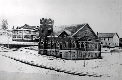 At left with church in the foreground. No date.