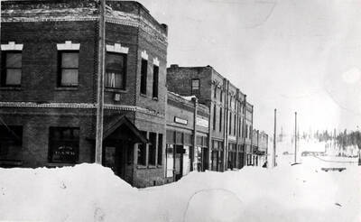 Between First and Railroad avenues. These brick buildings were built to replace the wooden buildings destroyed by the fire of July 4, 1914.