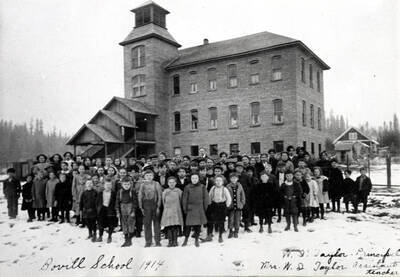 In 1914. To be razed as it has become antiquated. From a newspaper clipping dated November 12, 1956. Wording on photo: 'W.I. Taylor, Principal, Mrs. W.I. Taylor, Assistant teacher'.