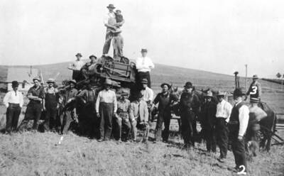 Manufactured in Moscow, 1911 model. Looking east across the Spokane & Inland Electric Railroad. The road beyond is now Highway 95 but not black-topped at this time. No. 1 in picture is Gainford (Gub) Mix, no. 2 Franklin E. Mix (father) and no. 3 Franklin Jr. Mix driving the horses. 1915.