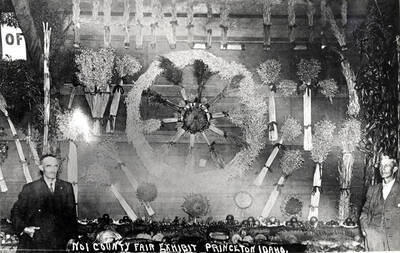 The bundles of grain at top of picture spell Princeton. Mr. Young at left in picture.