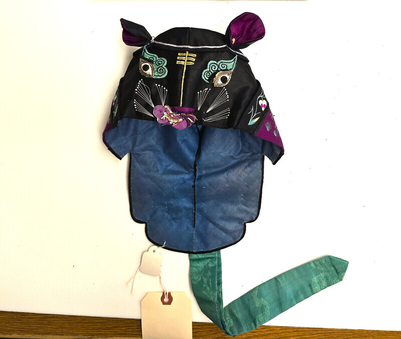 Silk children's hat with black dragon motif and embroidered neck flap.