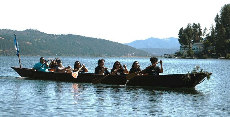 Members of the Coeur d'Alene Tribe ride a canoe.