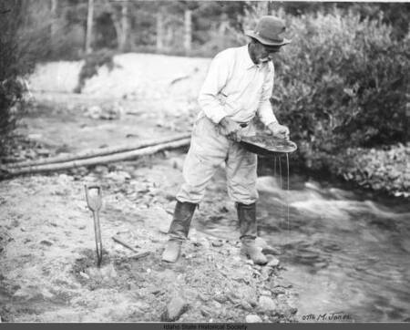 A picture showing the process of placer mining and the force of the hydraulic equipment