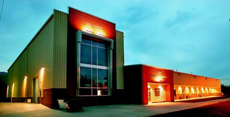 An outside photo of the Lewiston Morning Tribune's modern printing facility, a large light-colored industrial building with the newspaper's name displayed on the facade.