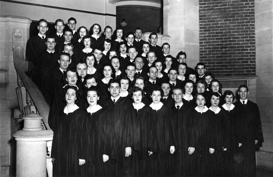 A group portrait of the Vandaleers standing on the staircase at the entrance of Memorial Gymnasium.