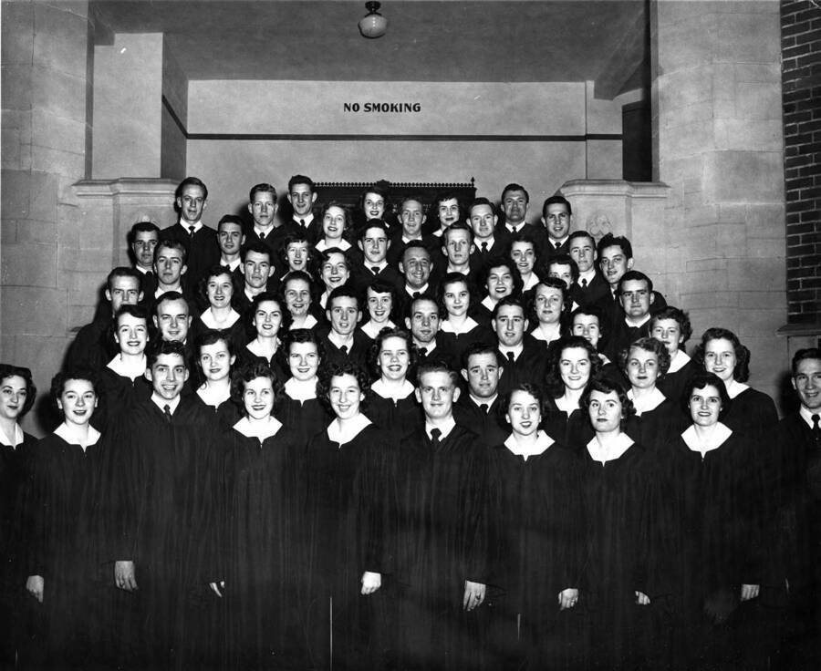 A group portrait of the Vandaleers standing on the staircase at the entrance of Memorial Gymnasium.