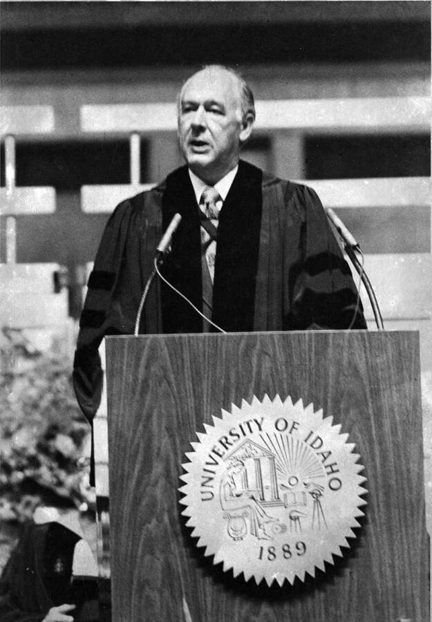Governor Cecil Andrus addresses the graduates and crowd during University of Idaho's commencement. He also received as honorary Doctor of Laws degree.