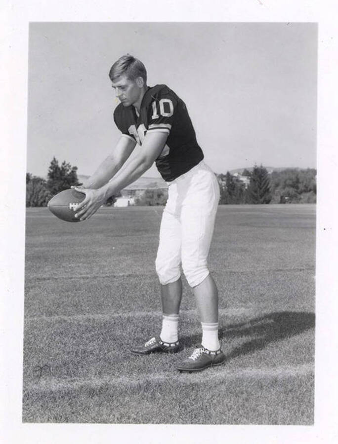 Jim Wickboldt, a defensive back for the University of Idaho, holding a football.