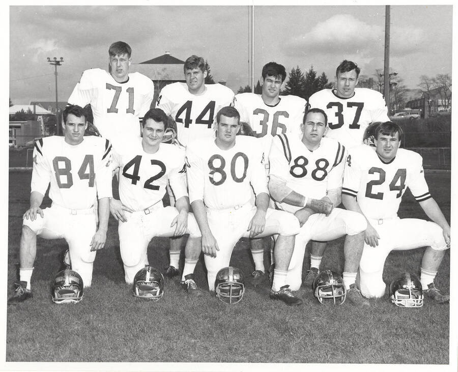 A group of nine unidentified University of Idaho football players grouped and posed together for the photograph.