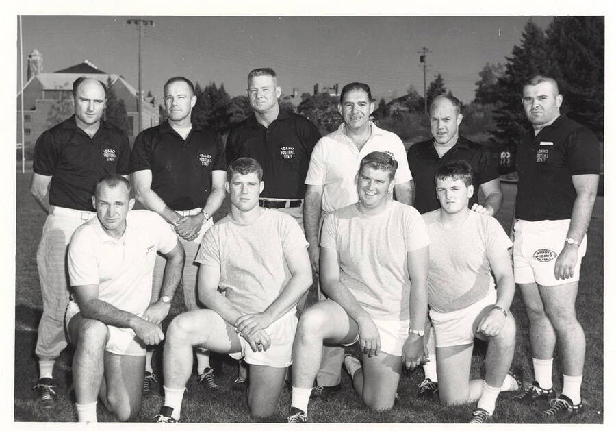 A group photo of the Vandal football coaching staff: (back) Bill Hughes, Walt Anderson, John Smith, Steve Musseau, Herb Adams, John Rallis; (front) Norm Thomas, Jack Bryant, Joe Dobson, and Larry Santschi.