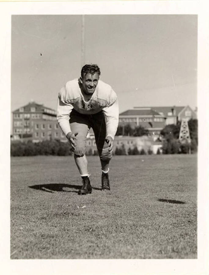 Charles LeRoy Atkinson, left halfback for the University of Idaho football team, preparing to catch the ball.