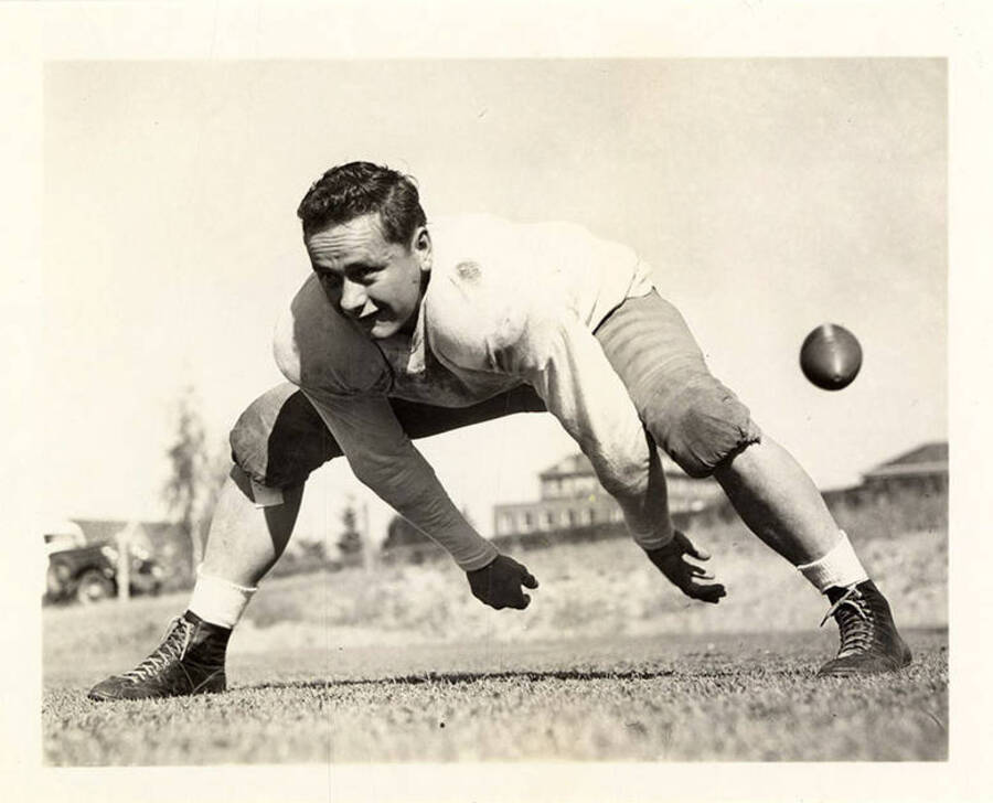 Center for the University of Idaho football team, Tony Aschenbrenner, hiking the ball for an action shot.