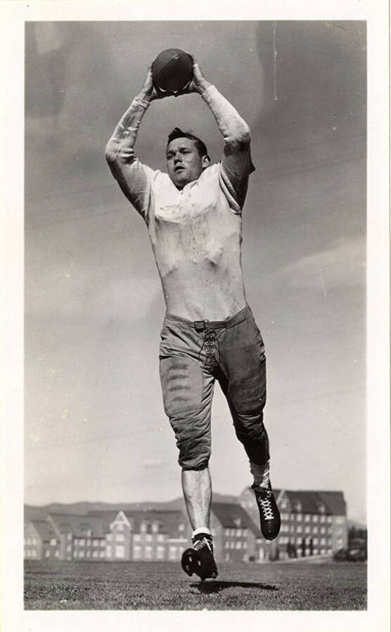 Joe Harrell, a University of Idaho football player, catching a football mid-air.