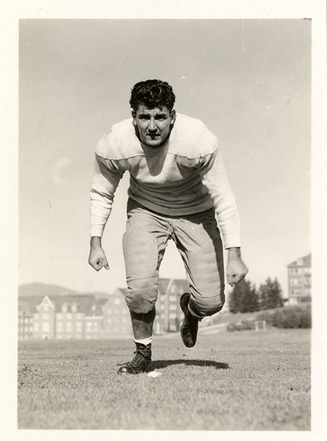 William Piedmont, tackle for the University of Idaho football team, running towards the camera for the action shot.