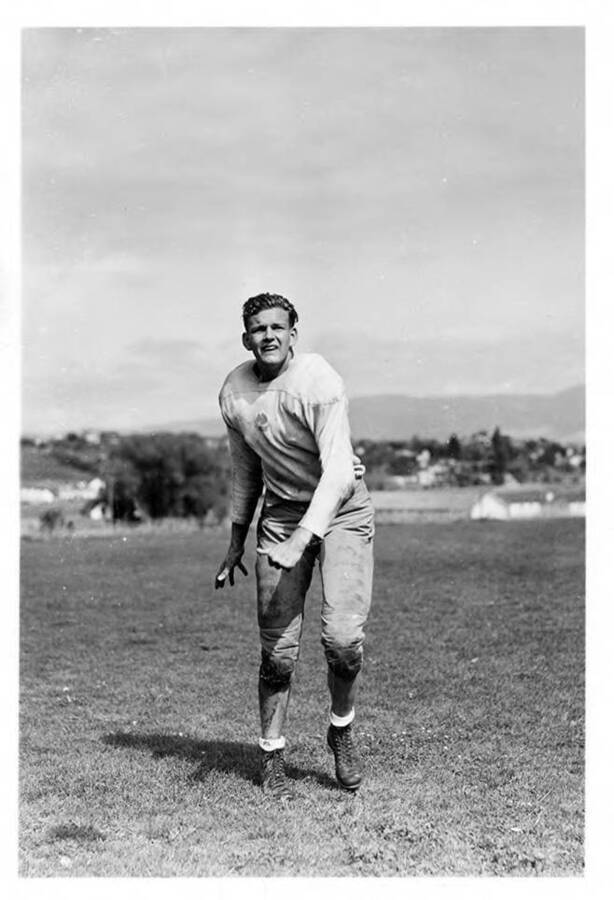 An action shot of Fred Nichols, a halfback for the University of Idaho football team.