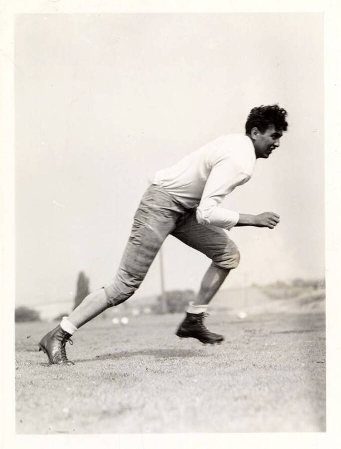Tackle for the University of Idaho football team, Joe Piedmont, running on the field.