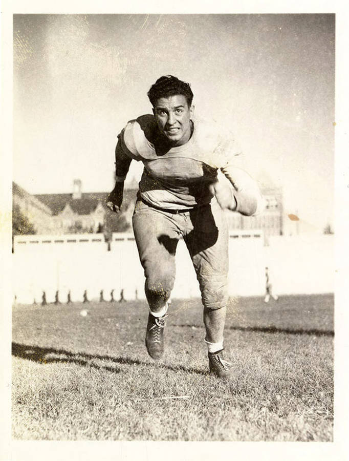 Joe Piedmont, tackle for the University of Idaho football team, running towards the camera.