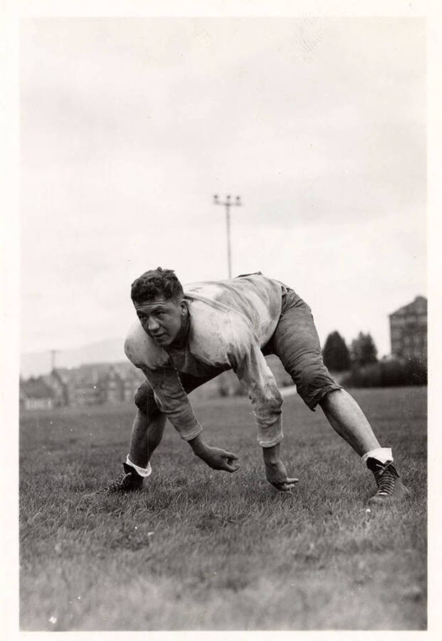 Football player  of the University of Idaho football team, Tom Solinsky, crouching on the field.