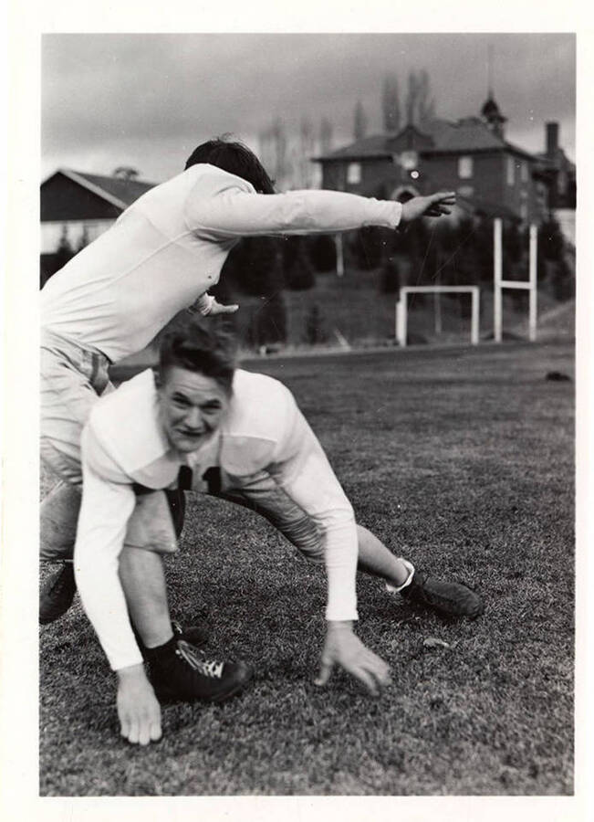 Freshman Lyle Kerby mid-tackle with another University of Idaho football player.