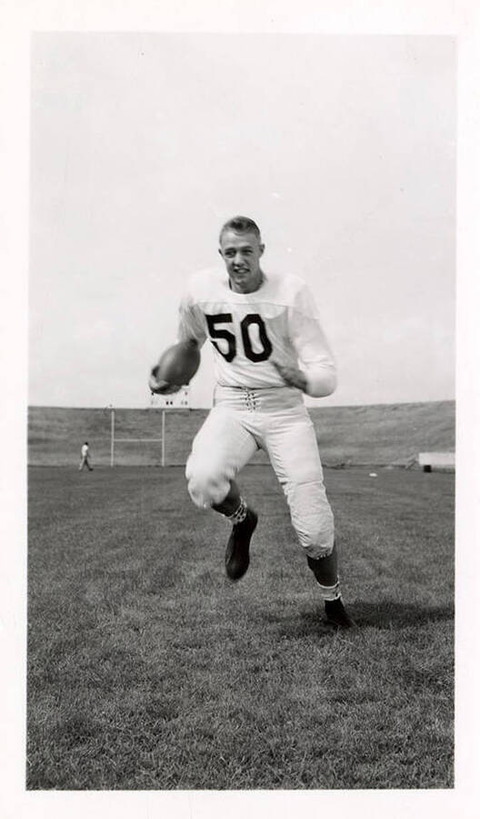 Freshman football player for the University of Idaho, Bill Lawr (#50), running.