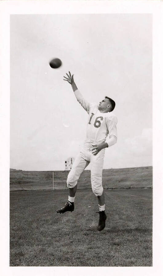 Freshman football player for the University of Idaho, Louis Mendicla, reaching for ball mid-air.
