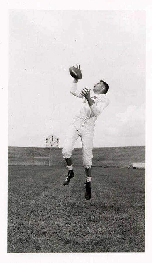 Freshman football player for the University of Idaho, Louis Mendicla, catching a football.