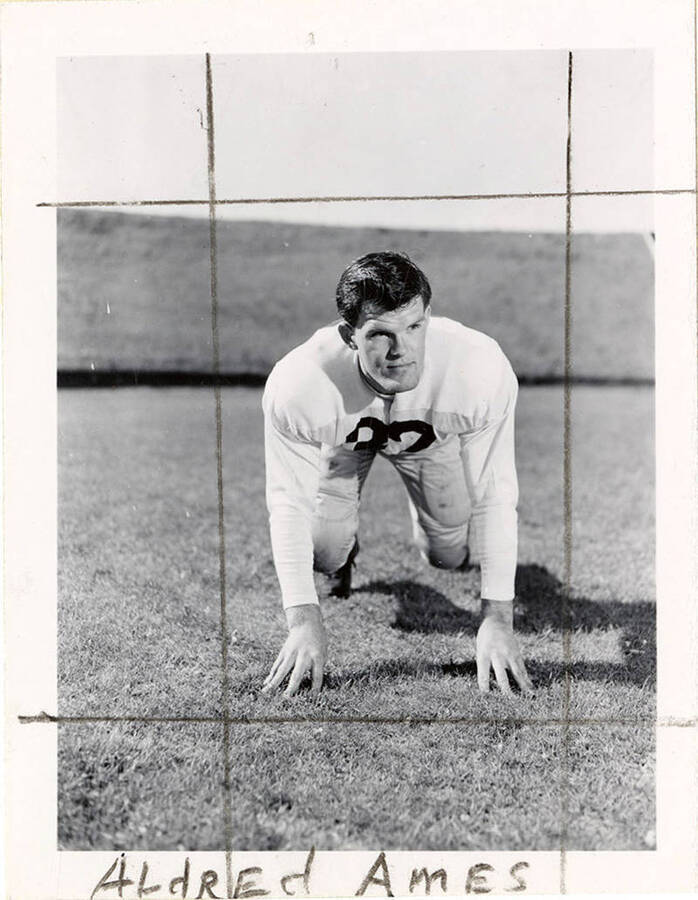 University of Idaho football player Aldred Ames crouching on the field.