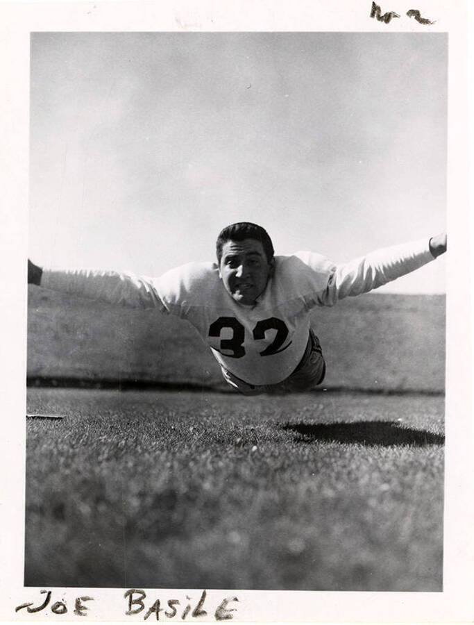 University of Idaho football player, Joe Basile (#32) mid-air before he hits the ground.