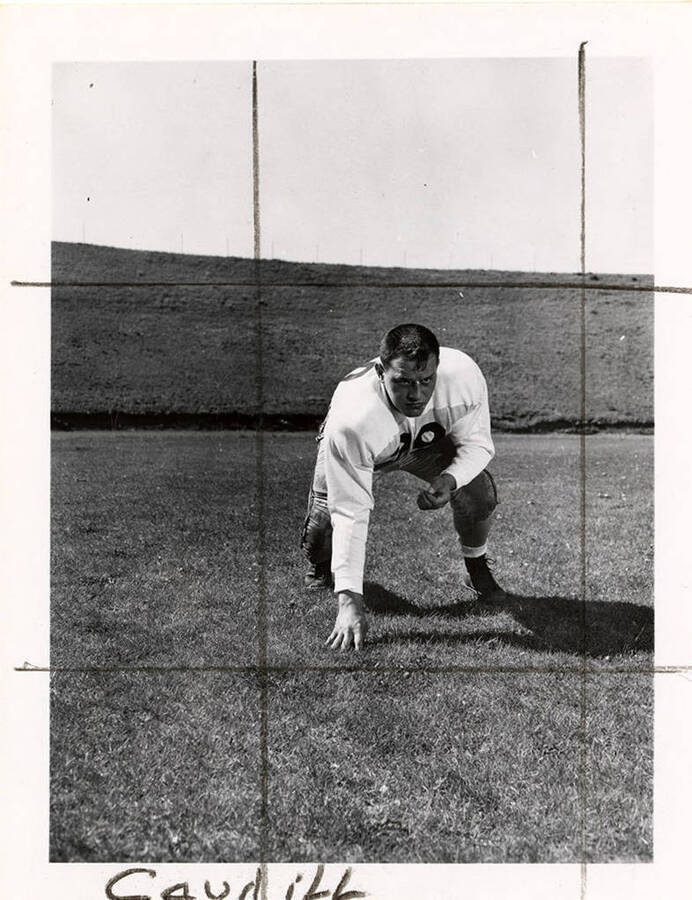 Neil Caudill, a guard for the University of Idaho football team, crouching on the football field.