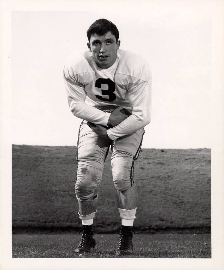 Fullback for the University of Idaho football team, Bob Cruickshank, holding a football.