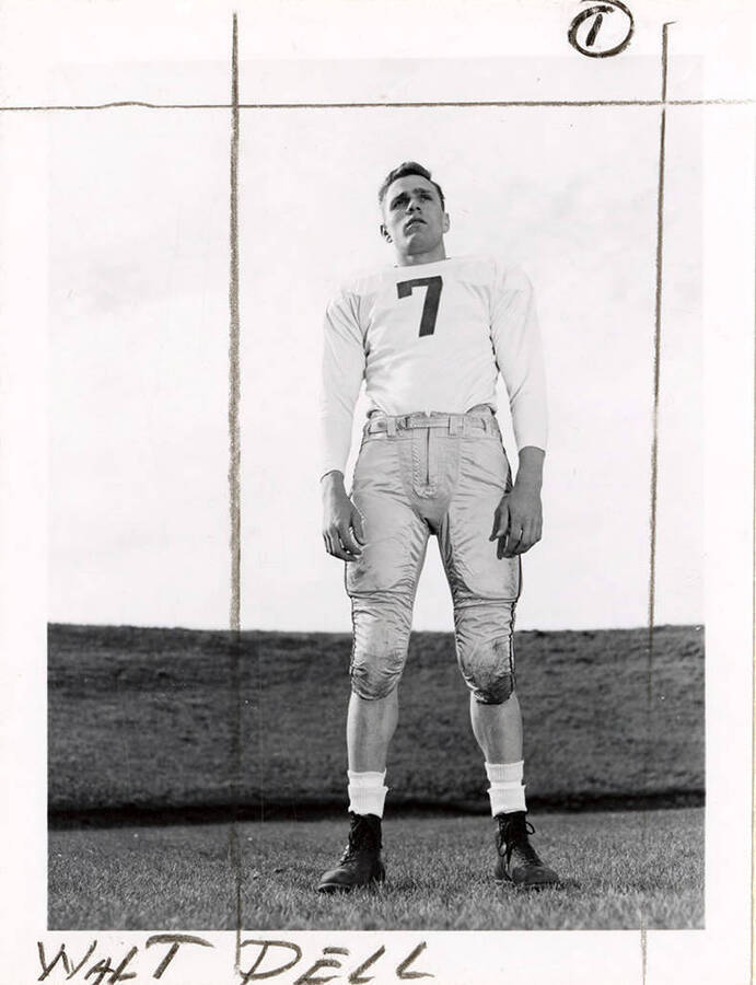 Walt Dell (#7), right halfback for the University of Idaho football team, standing on the field.