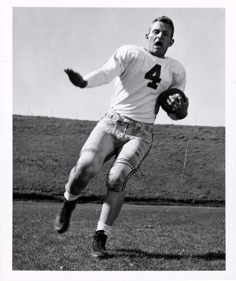 Action shot of quarterback Larry Hart (#4) of the University of Idaho football team.