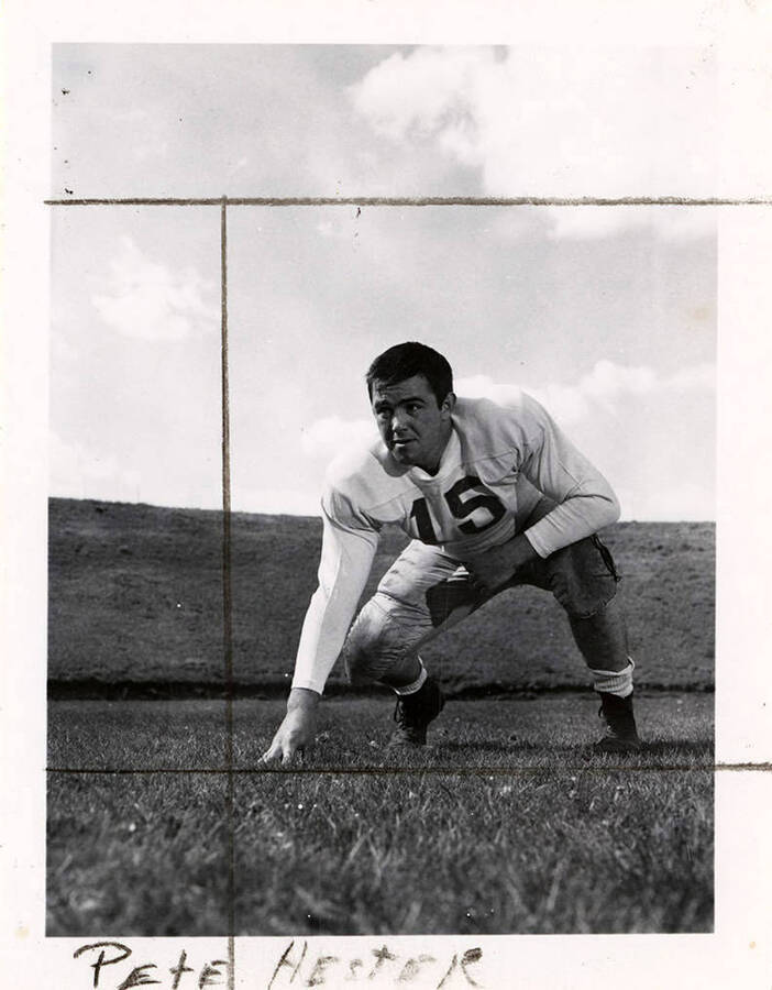 Football player, Peter Hester (#30), a guard for the University of Idaho, crouching on the football field.