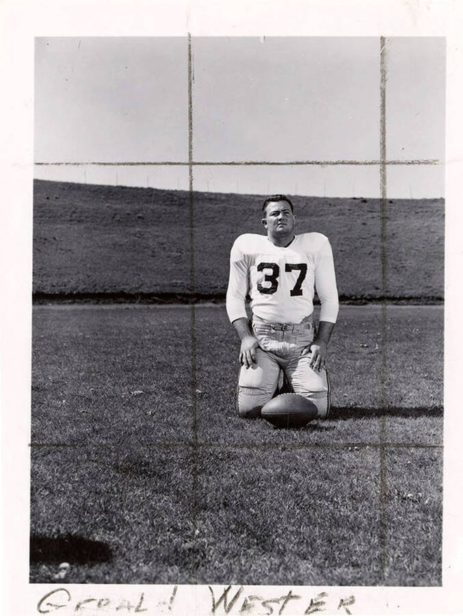Gerald Wester (#37), a player for the University of Idaho football team, kneeling on the field with a football.