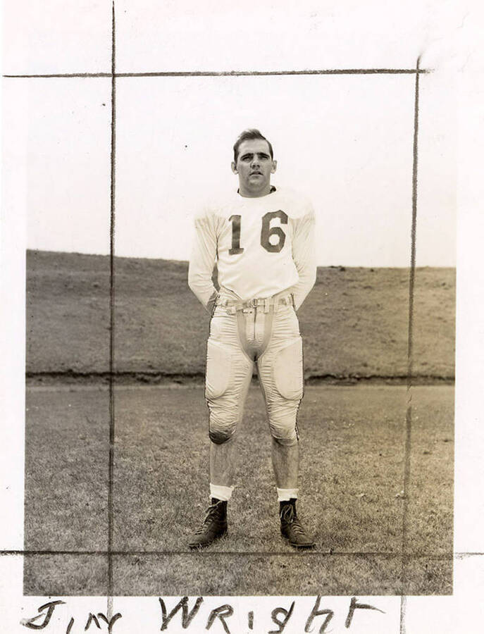 Football player for the University for Idaho, Jim Wright (#16), standing.