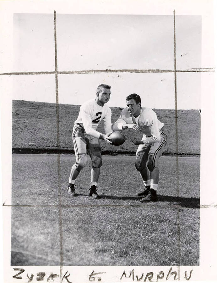 University of Idaho football players, Dave Murphy receiving a ball from quarterback Dick Zyzak.