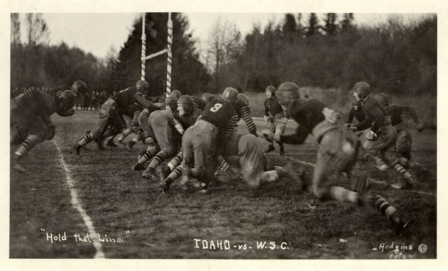 The first tackles begin as the players try to 'hold the line' at the beginning of a play during the University of Idaho vs. Washington State College football game
