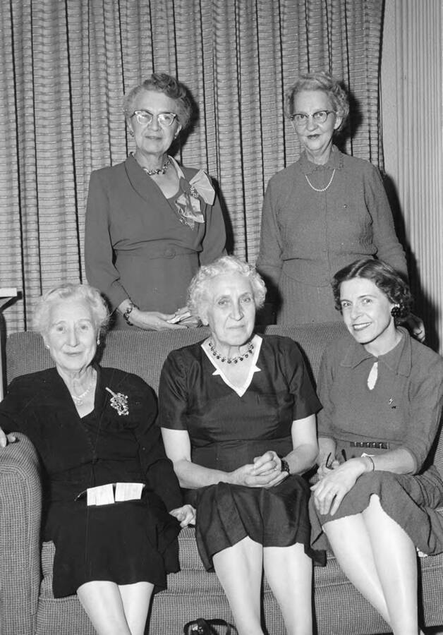 Former members of Kappa Alpha Theta posing together for a photograph at the Kappa Alpha Theta house. Standing, l-r: Eunice Merrill, Pearl Hadley. Seated, l-r: Maud Iddings, Gertrude Axtell, Mildred M. Hensley.