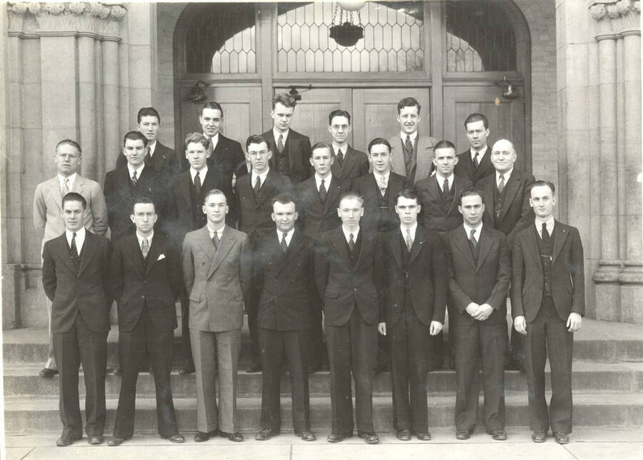 Phi Eta Sigma members stand outside of the Memorial Gym for a group photo. Phi Eta Sigma is a freshman national scholastic honorary society. Individuals are identified on board mount.