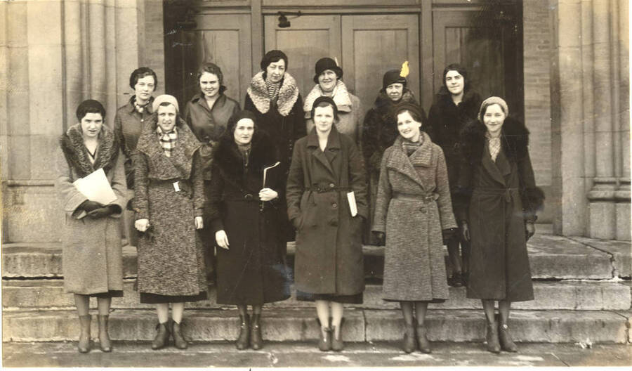 Phi Upsilon Omicron members stand for a group photo outside of the administration building in their winter coats. Phi Upsilon is a national professional home economics fraternity.