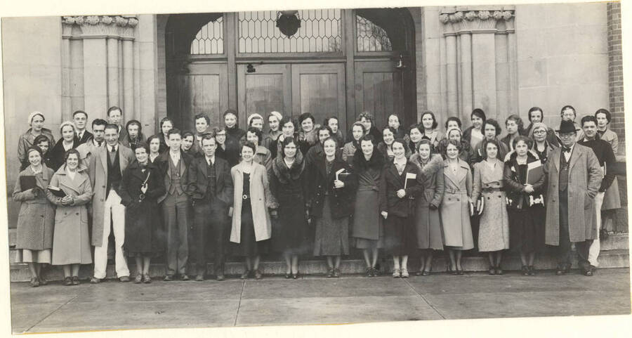 The English Club stands in front of the Adminstration building for a group photo.