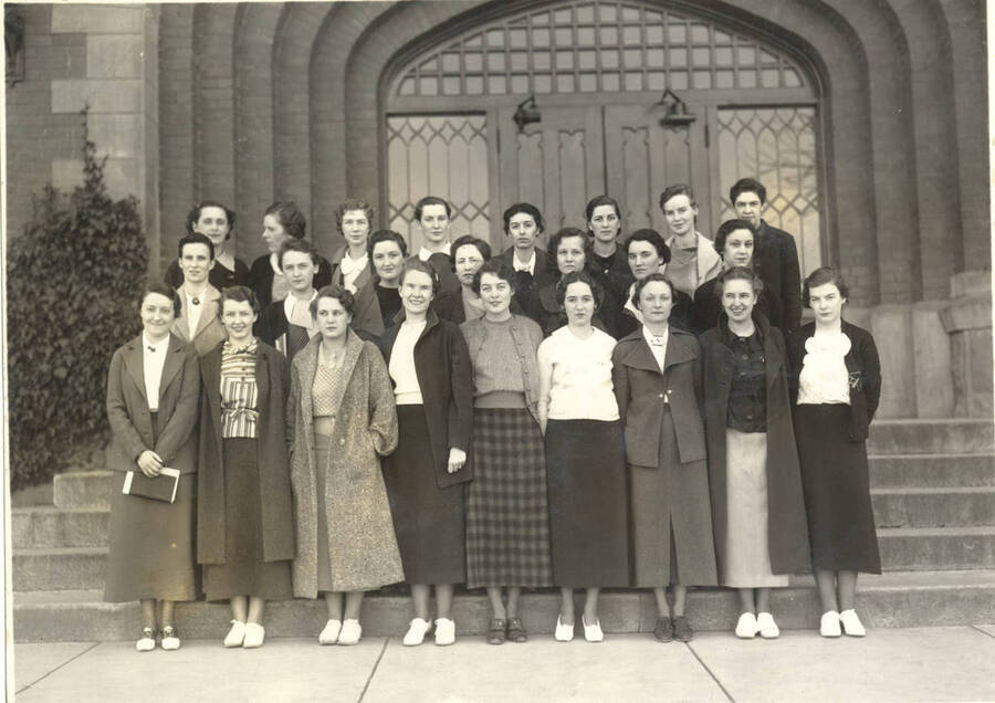 The Cardinal Key members stand in front of a building for a group photo.The Cardinal Key is a national upperclasswomen's service honorary society. Individuals identified as listed. Front: V. Merrick, R. Farley, M. Rehberg, E. Hunt, M. Hartley, M. Illingsworth, R. Ferney, D. Dole, J. Kinney; middle: R. Evans, N. Varian, H. Latimore, C. Campbell, S. Evans, W. Mitchell, F. Wimer; back: M. Druding, R. Roark, C. Daly, M. Riley, etc.