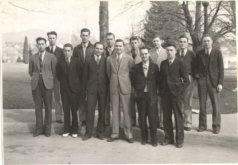 Blue Key members pose for a photo in front of the Administration lawn. Blue Key is a national upperclassmen's honorary fraternity. Individuals identified as listed. Back: Robert Campbell, William McCrea, Raul Rust, Dwain Vincent, Cecil Greathouse, Hugh Eldridge, William Wetherall; front: Carl Morfitt, Maurice Malin, Robert Bennett, Earl Bopp, Charles Warner, Conrad Frazier
