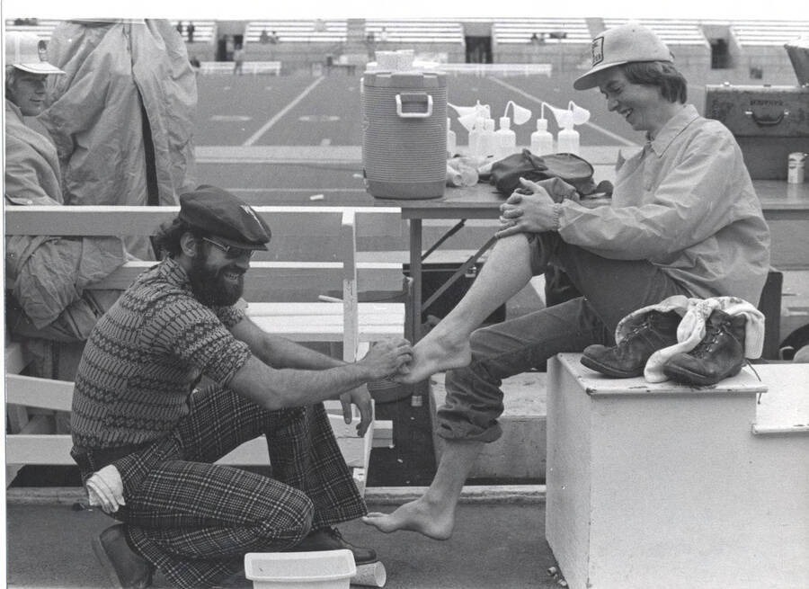 WSU's student body president washes the ASUI president's feet after completing the Loser's Walk from Moscow, Idaho, to Pullman, Washington. The Loser's Walk tradition stems from the losing team of the Battle of the Palouse game walking to the winning team's stadium.