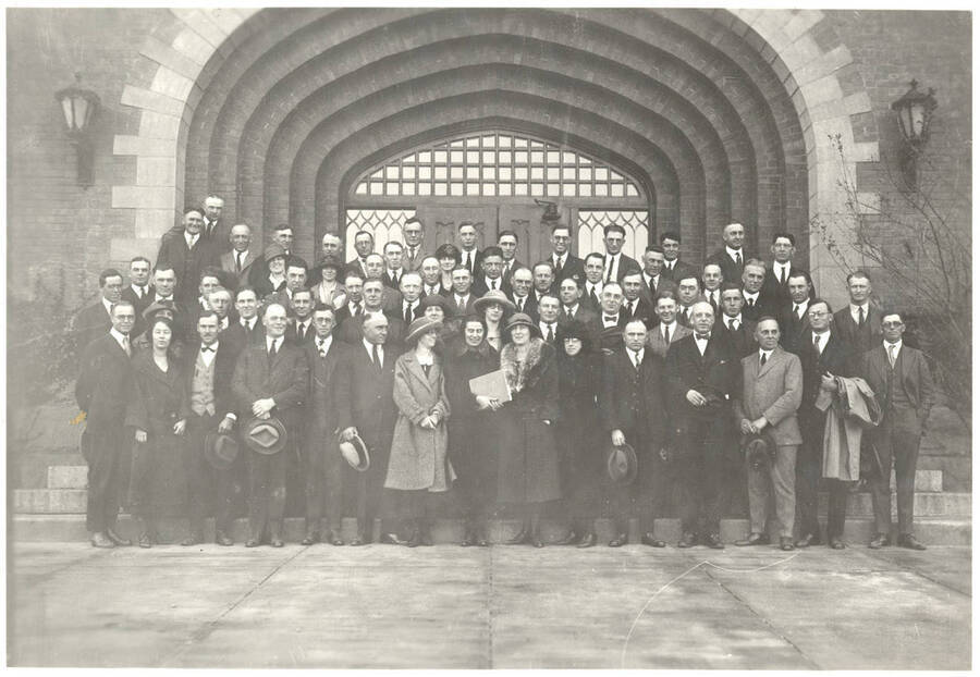 Staff, including extension and experiment station staff, attending the Agricultural College conference pose for a group photo in front of the north entrance of the Administration Building.