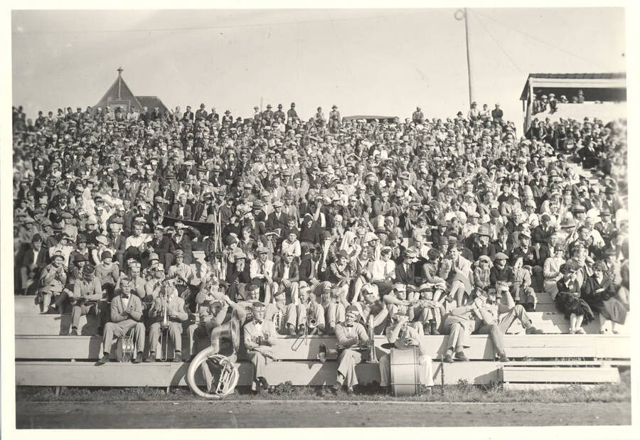 The Marching Band and students sit during a University of Idaho football game on MacLean Field.