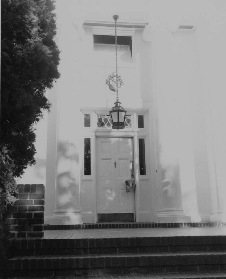 The front entranceway of Sigma Nu house, located at 718 Elm Street with shoes hanging off the door knob.
