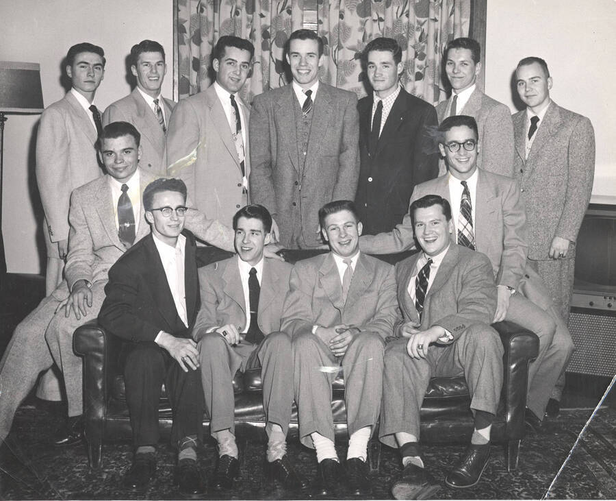 Members of the Beta Theta Pi fraternity pose for a group photo in their house.